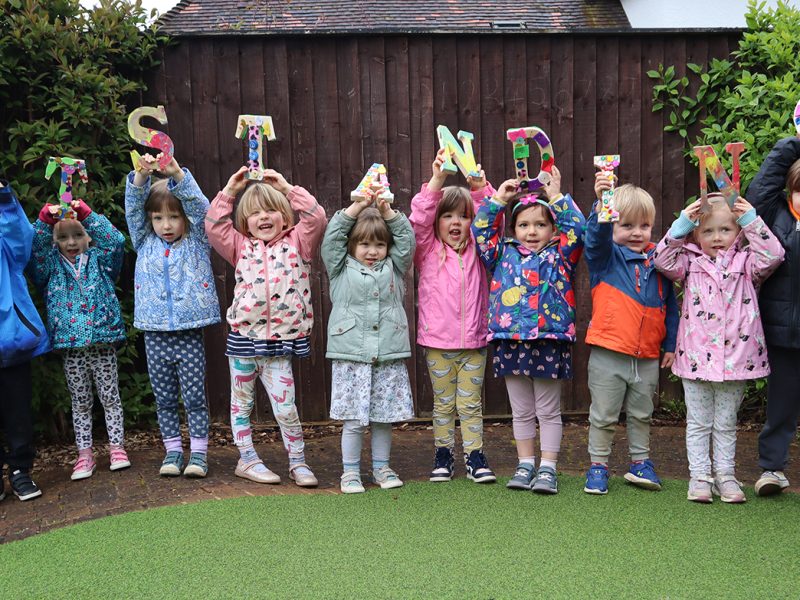 Children at Red Bus Nursery celebrate the successful Ofsted findings