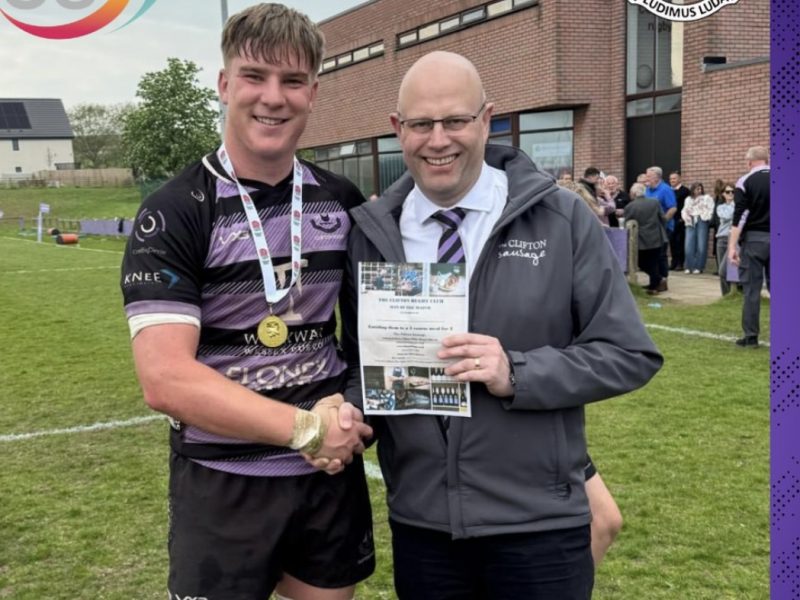 Shay Sainsbury receives a Man of the Match award from Simon Quarrie of the Clifton Sausage